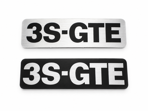 Reproduction 3S-GTE timing cover decals: silver (black letters on brushed aluminum) and black (brushed aluminum letters on black)